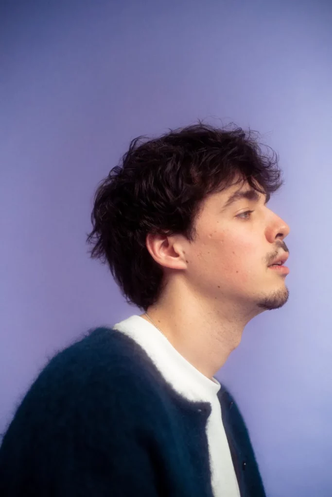 Caro, an artist on No Nothing Records, photographed in profile against a lilac background